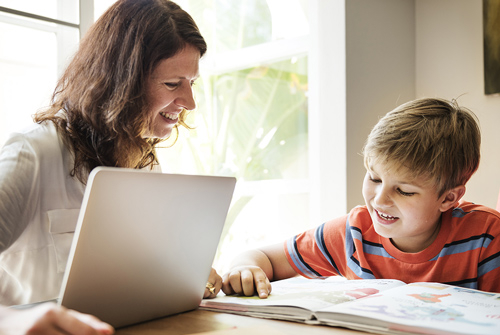 Mother and son doing homework together